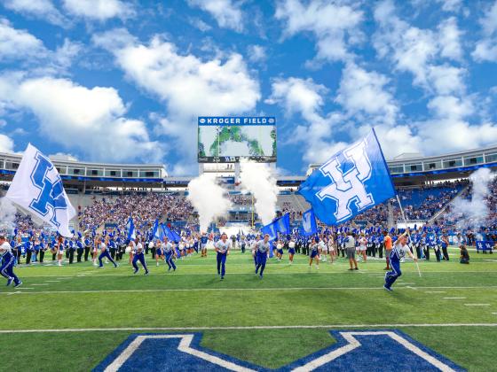 UK Cheerleaders running on the football field